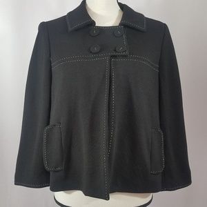 Short black blazer with white stitching